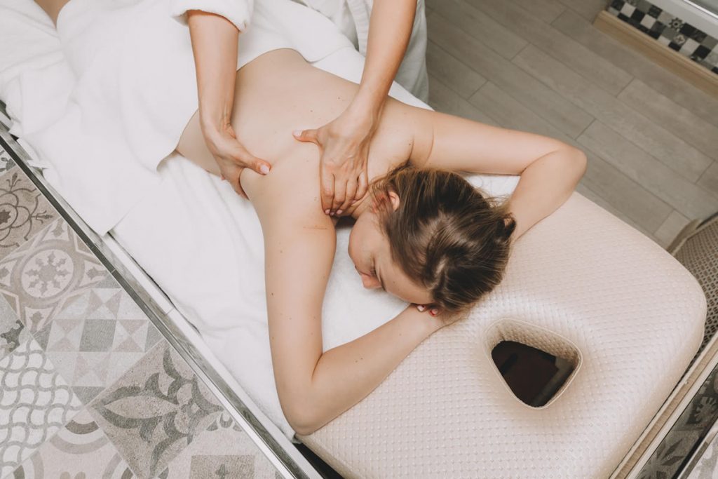 mujer tumbada haciendo un masaje